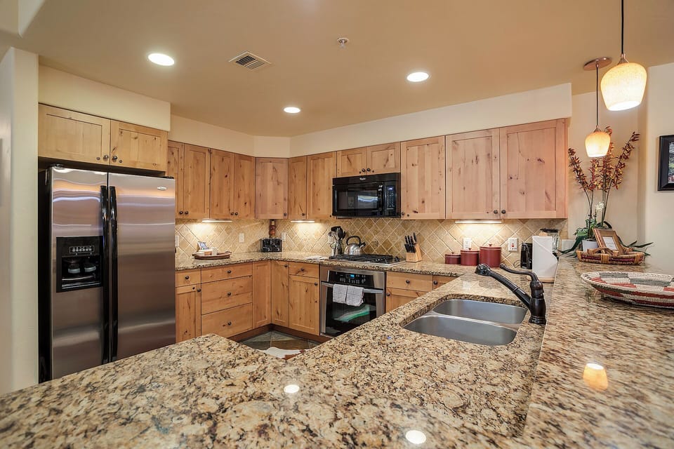 Your fully-equipped kitchen features warm wood cabinetry, gleaming granite countertops, stainless steel appliances, and all the tools you need to prepare delicious home-cooked meals during your stay.