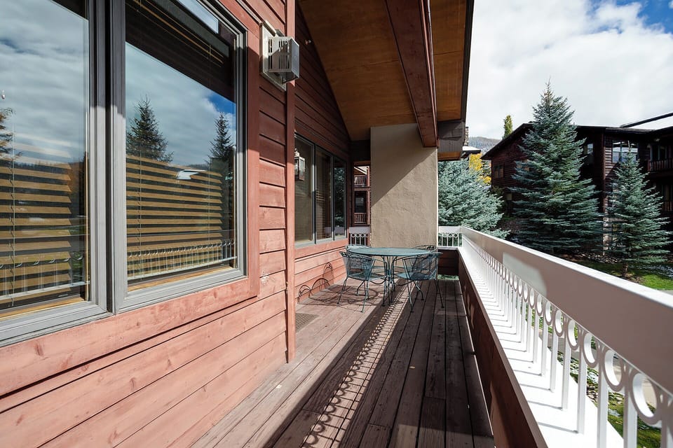 Private balcony overlooking evergreen trees—perfect for morning coffee or evening relaxation in the fresh mountain air.