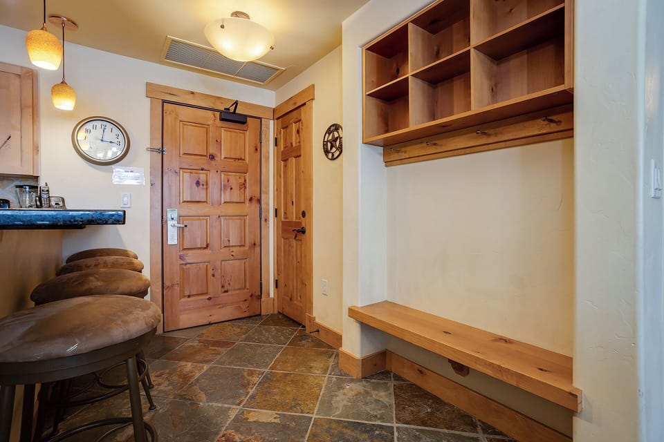 Step into your welcoming entryway with warm wood accents and ample storage space to organize your gear after mountain adventures.