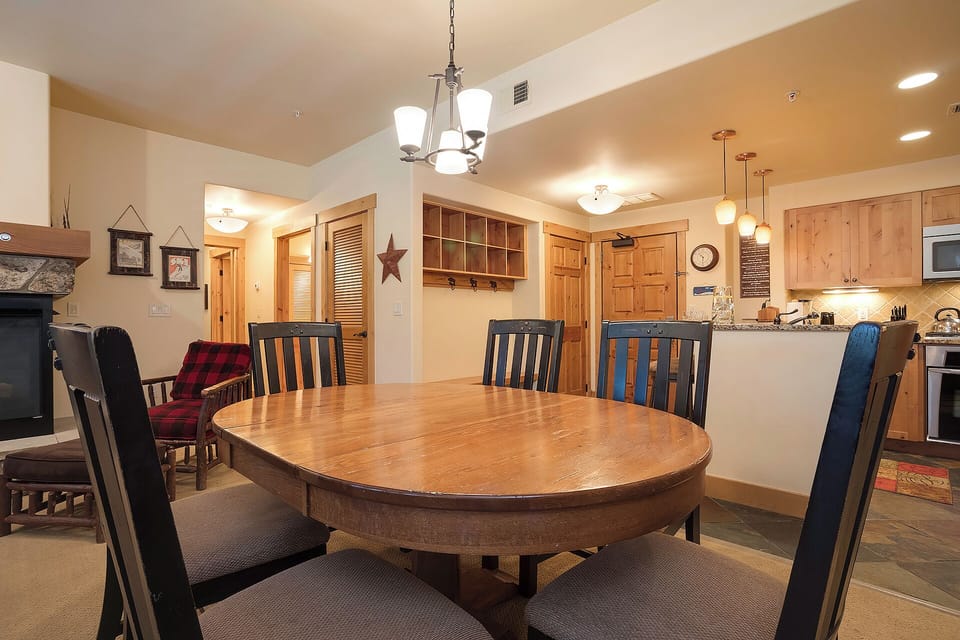 Gather around this spacious dining table where your group can share meals and stories together in warm, welcoming comfort.
