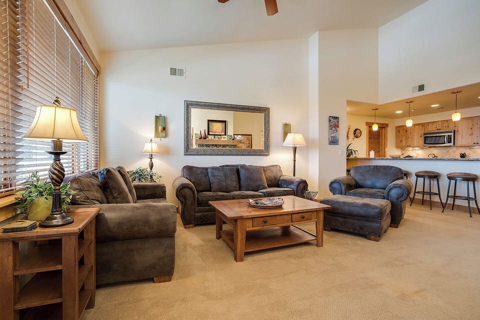 Sink into plush sofas and armchairs where warm lighting and rustic wood details create your perfect mountain retreat for relaxing evenings together.