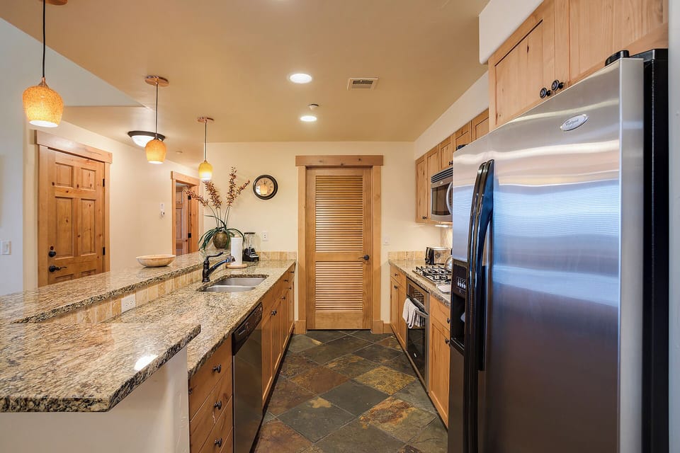 Your spacious kitchen features granite counters, stainless appliances, and warm wood cabinetry—ready for cooking, gathering, and making memories together.
