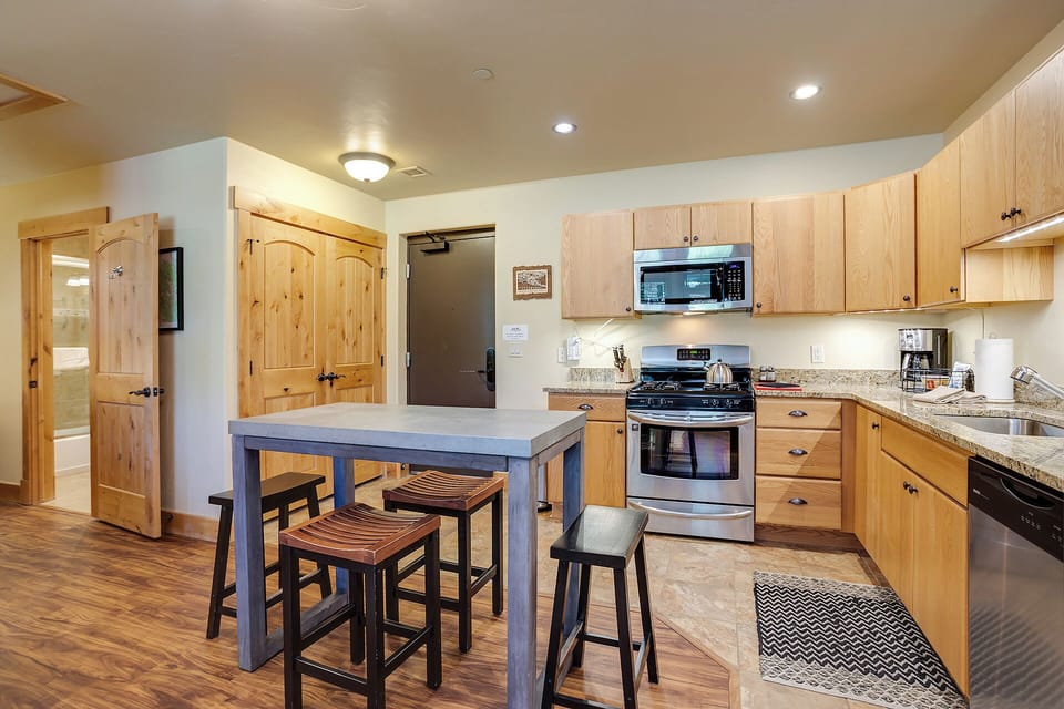 Your fully equipped kitchen invites easy meal prep with granite counters, stainless appliances, and a cozy breakfast island for quick bites or morning coffee with loved ones.