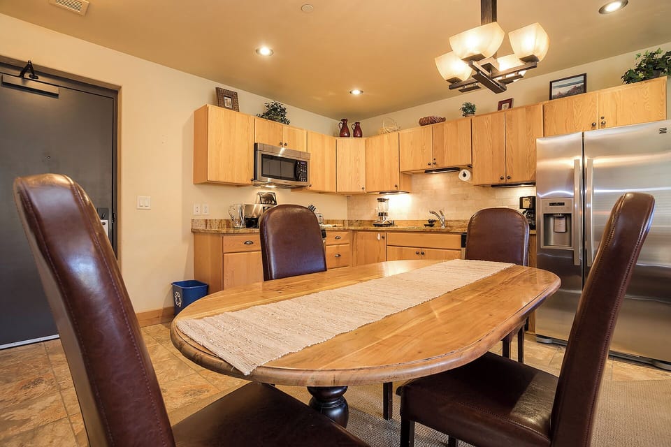 Gather around your private kitchen and dining space, where warm wood tones and stainless steel appliances create the perfect setting for shared meals and morning coffee together.