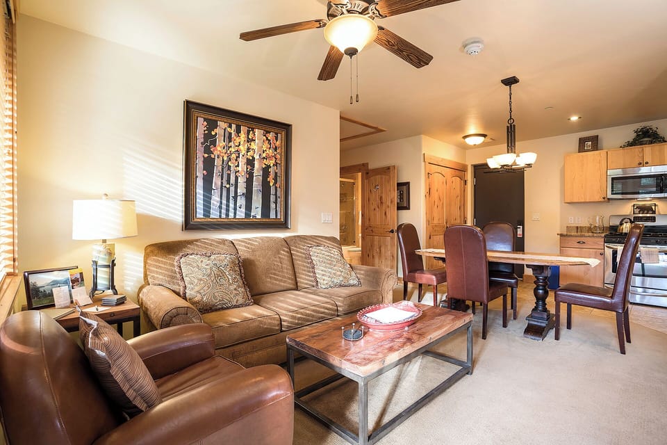Your cozy open living space invites you to unwind on plush seating after a day exploring, with a fully-equipped kitchen and dining area ready for memorable meals together.