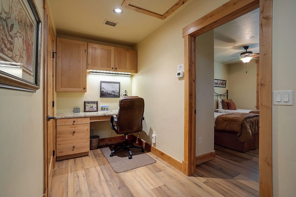 Your own quiet workspace awaits, complete with a built-in desk, warm wood tones, and thoughtful lighting—perfect for catching up on emails or planning your next adventure in comfort.