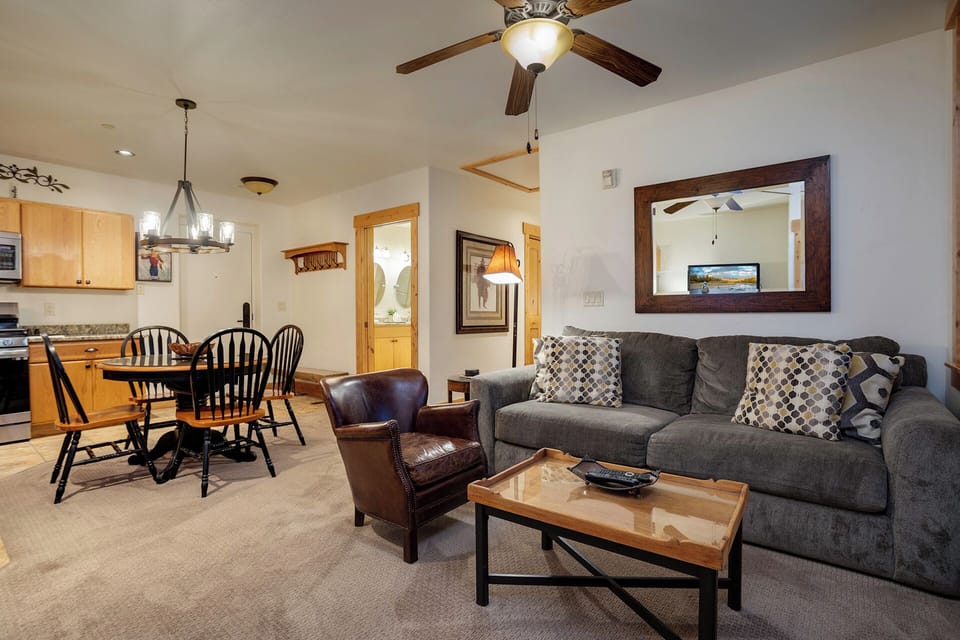 Relax in your open-concept living space with cozy seating, stylish decor, and seamless access to the dining area and kitchen—perfect for unwinding or entertaining.