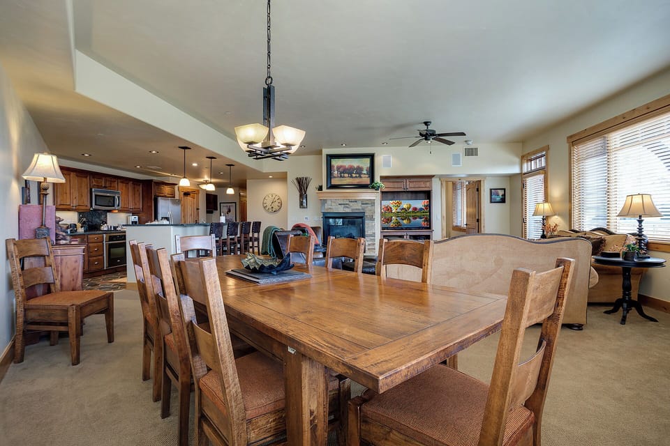 Your open-concept gathering space blends dining, kitchen, and living areas—perfect for memorable meals and cozy evenings by the fireplace with loved ones.