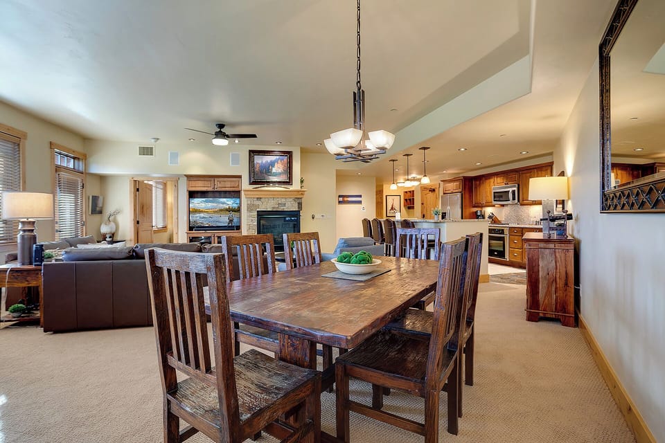 Gather around the handcrafted dining table where your group can share meals and stories. The open layout connects you to the cozy living room and well-equipped kitchen, creating a warm space for togetherness.