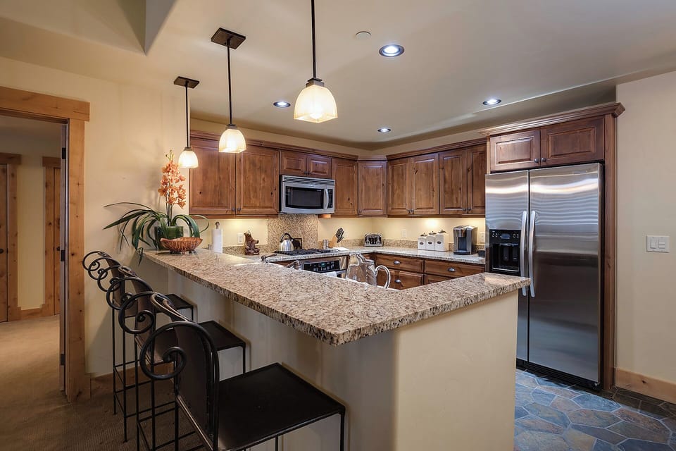 Step into your fully equipped kitchen, where granite countertops and stainless steel appliances await your culinary creations. Gather at the island with seating for casual meals or coffee.