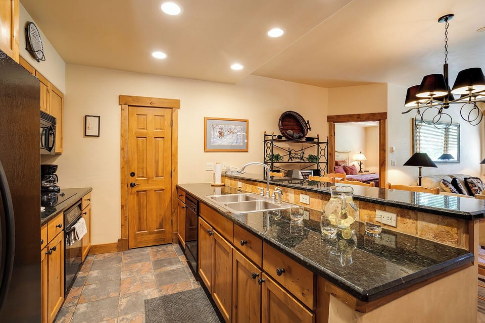 Step into this welcoming kitchen where rich wood cabinetry and polished granite counters invite you to gather, cook, and create memories with loved ones during your stay.