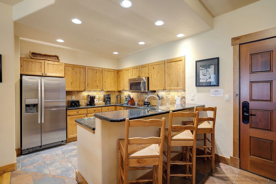 Step into your fully-equipped kitchen with granite counters, modern appliances, and a cozy island with seating—perfect for preparing meals together and sharing stories over coffee.