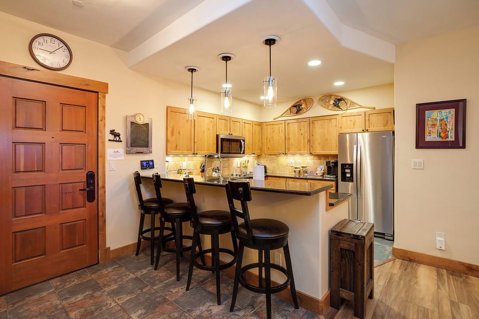 Step into your cozy retreat where a fully-equipped kitchen awaits with granite counters, stainless appliances, and a breakfast bar perfect for morning coffee or evening conversation.