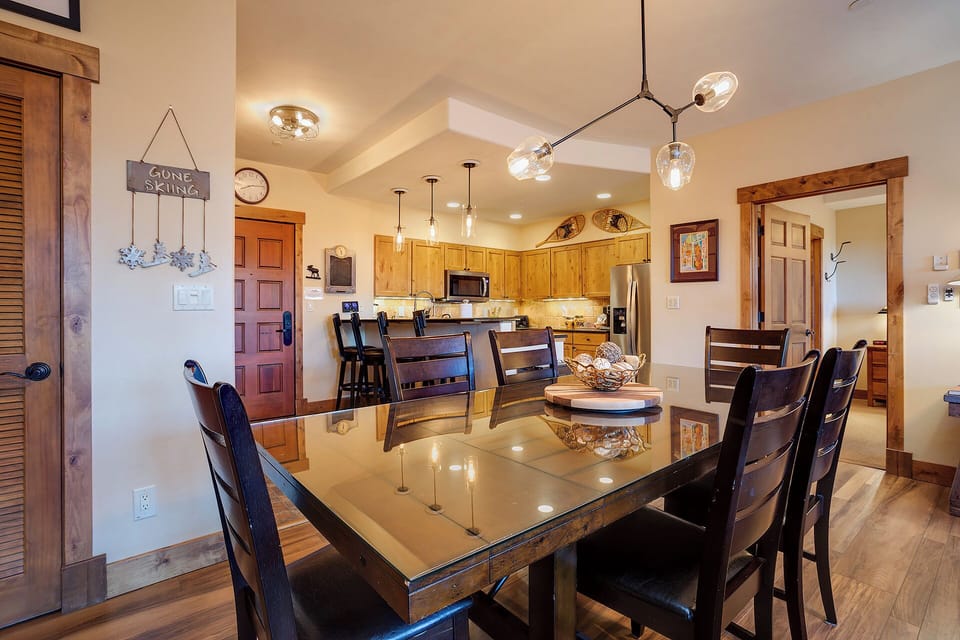 Gather around your spacious dining table with room for everyone, opening to a fully-equipped kitchen where you can prepare meals together and create lasting vacation memories.