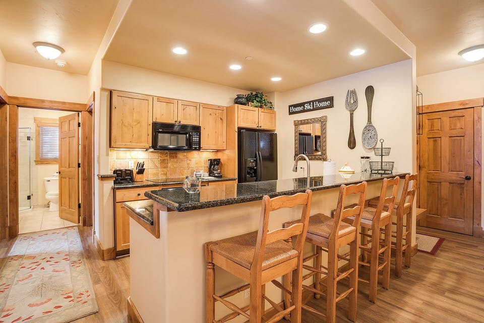 Gather around this spacious kitchen island with bar seating for six. Cook together in your fully equipped kitchen with modern appliances and granite counters, then savor every meal in comfort.