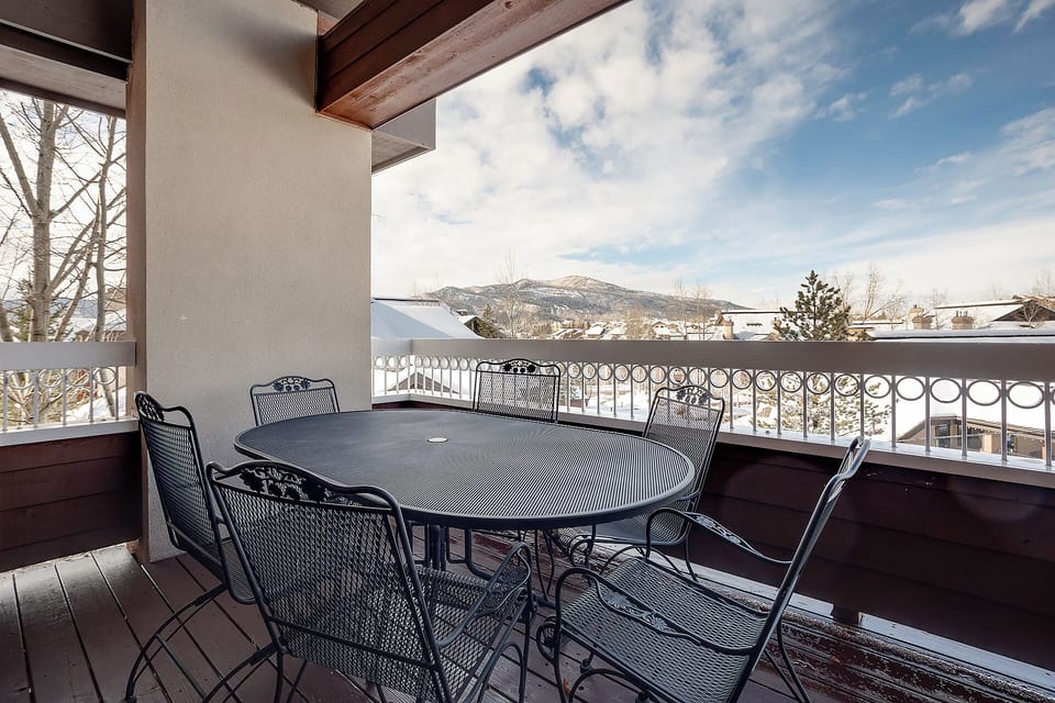 Enjoy morning coffee or evening conversations at this private balcony with stunning mountain views. The spacious table seats six comfortably amid crisp alpine air.