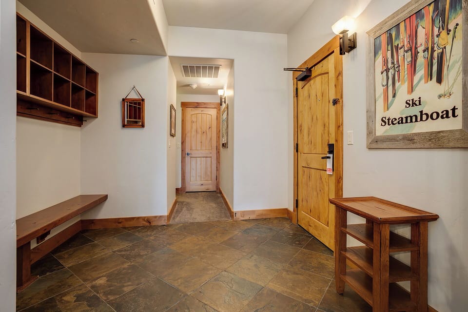 Store your skis and boots in this spacious mudroom before settling into your mountain retreat. Natural wood storage and benches keep your gear organized and ready for tomorrow's slopes.