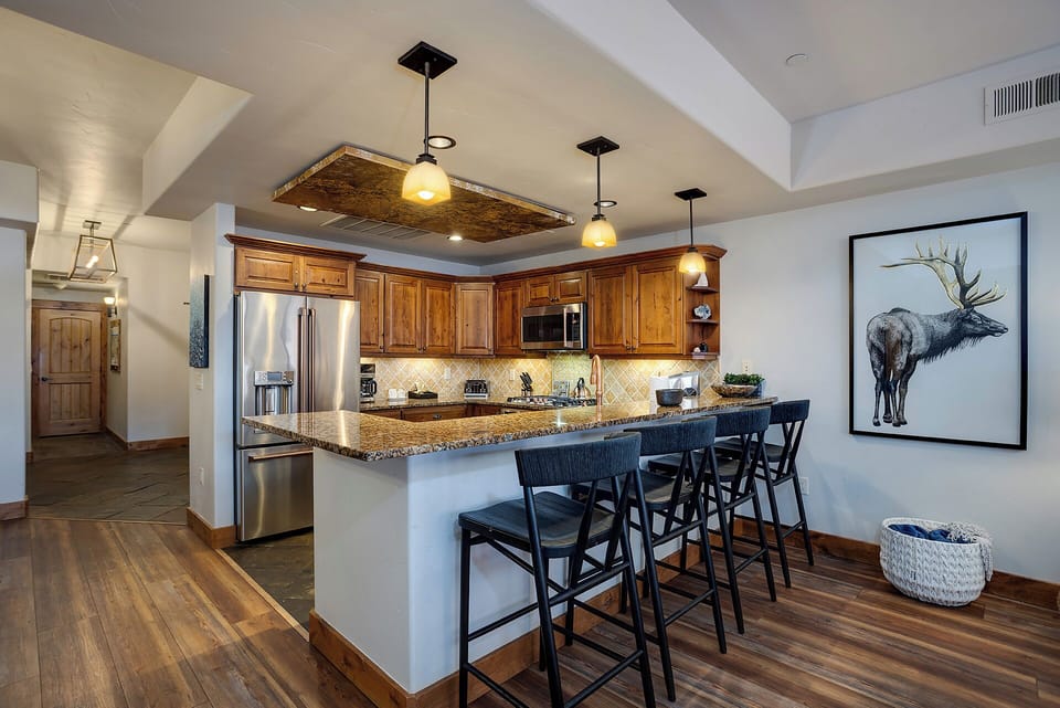 Gather at your spacious granite-topped island with seating for six. Warm wood cabinetry and stainless appliances make this fully-equipped kitchen ready for memorable meals together.