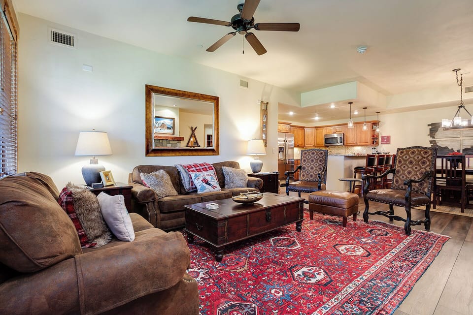 Sink into plush sofas and unwind in this inviting living area, where a warm color palette, stylish furnishings, and an open floor plan create your perfect home base for relaxation and mountain getaway memories.