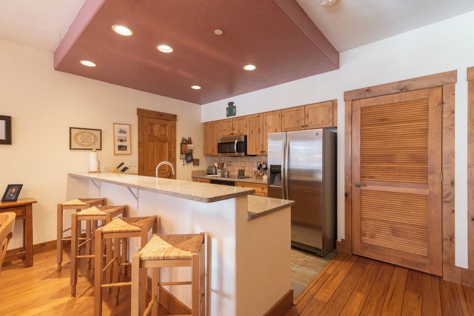Your gourmet kitchen invites you to gather and create, with granite counters, stainless appliances, and a breakfast bar perfect for morning coffee or evening conversations.