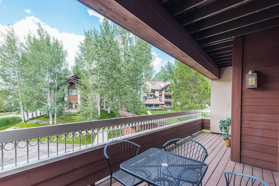 Sip your morning coffee on this covered balcony, where peaceful tree views and mountain air set the tone for your day.