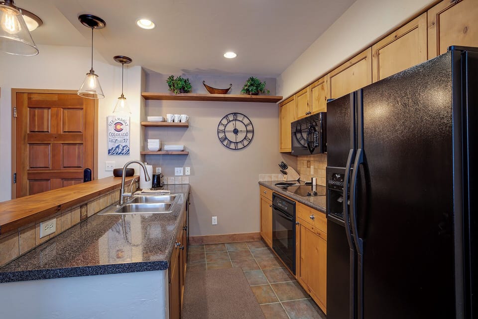 Your fully-equipped kitchen features granite countertops, modern appliances, and charming pendant lighting—perfect for preparing meals together or enjoying morning coffee before heading out to explore.