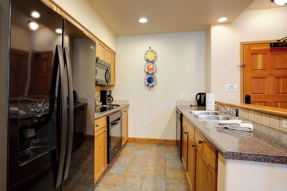 Your fully equipped kitchen features stainless steel appliances and granite countertops—perfect for preparing everything from morning coffee to a home-cooked meal after a day exploring.