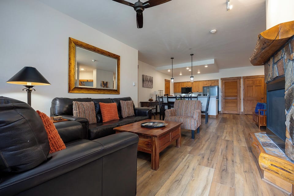 Step into your open-concept retreat with inviting living space, full kitchen, and cozy stone fireplace—a perfect home base after mountain adventures.