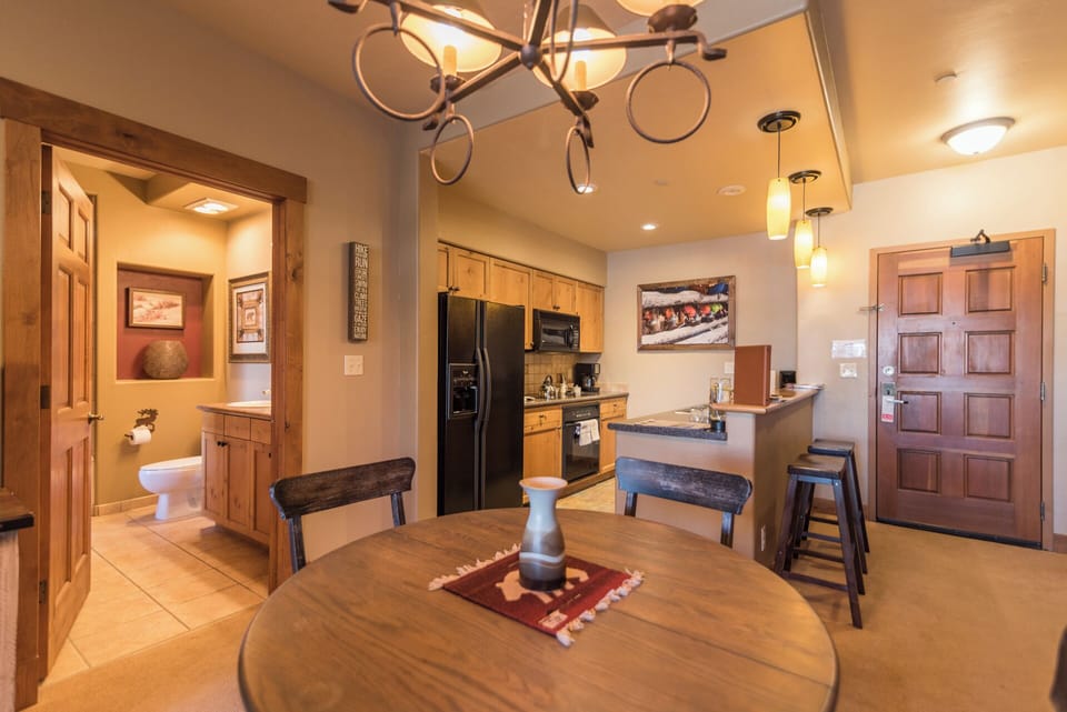Gather around your inviting dining table, enjoy the open-concept kitchen with stainless-steel appliances, and unwind in your warm, well-appointed space with rustic charm and modern comforts.