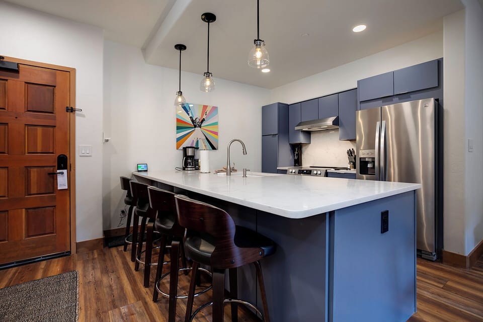 Your fully-equipped kitchen with sleek countertops and modern appliances makes it easy to prepare meals together while enjoying the open, inviting space.