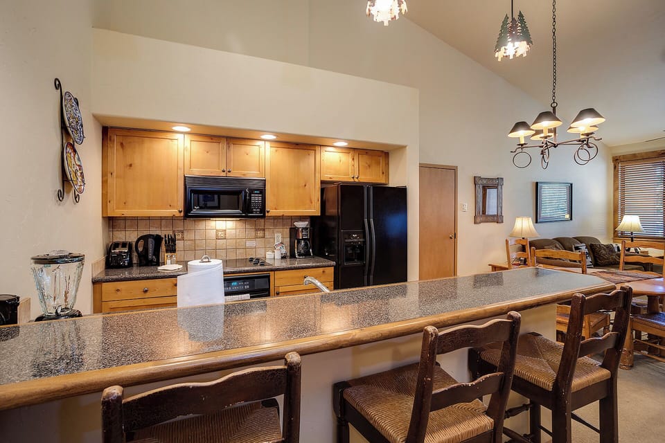 Step into your fully equipped kitchen with granite countertops, modern appliances, and breakfast bar seating—perfect for cooking meals and gathering with loved ones in comfort.