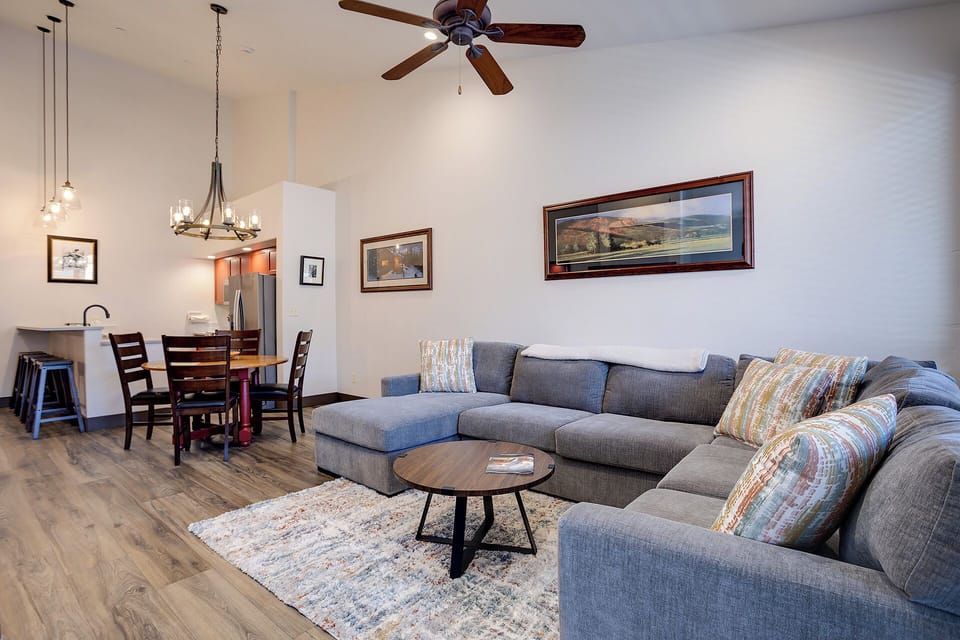 Sink into the plush sectional and unwind in your bright, open-concept living space, where high ceilings and thoughtful touches invite you to kick back and relax after a day of adventure.