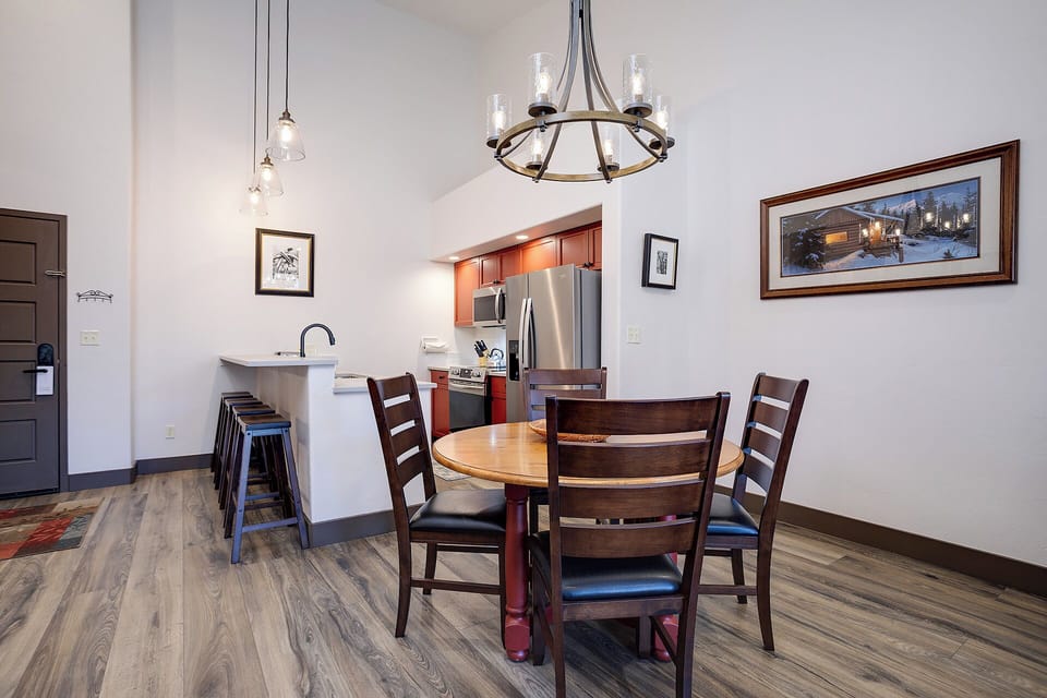 Gather around your private dining table beneath a stunning chandelier, with a fully equipped kitchen just steps away ready for home-cooked meals.
