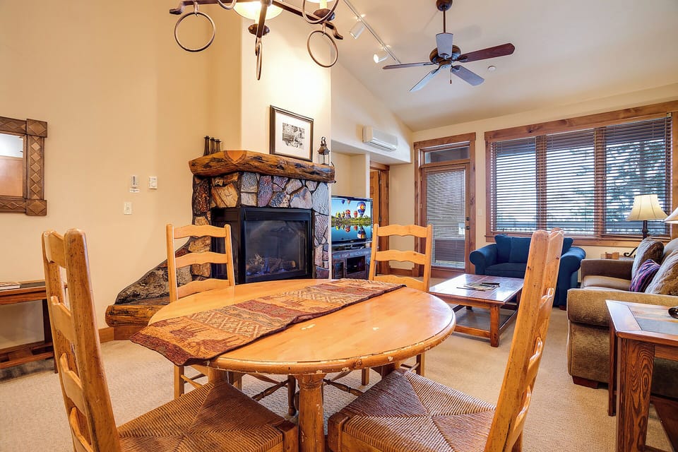 Gather around this warm, inviting space where rustic charm meets comfort. Your mountain retreat awaits with a stunning stone fireplace, spacious dining, and cozy seating perfect for evenings in.