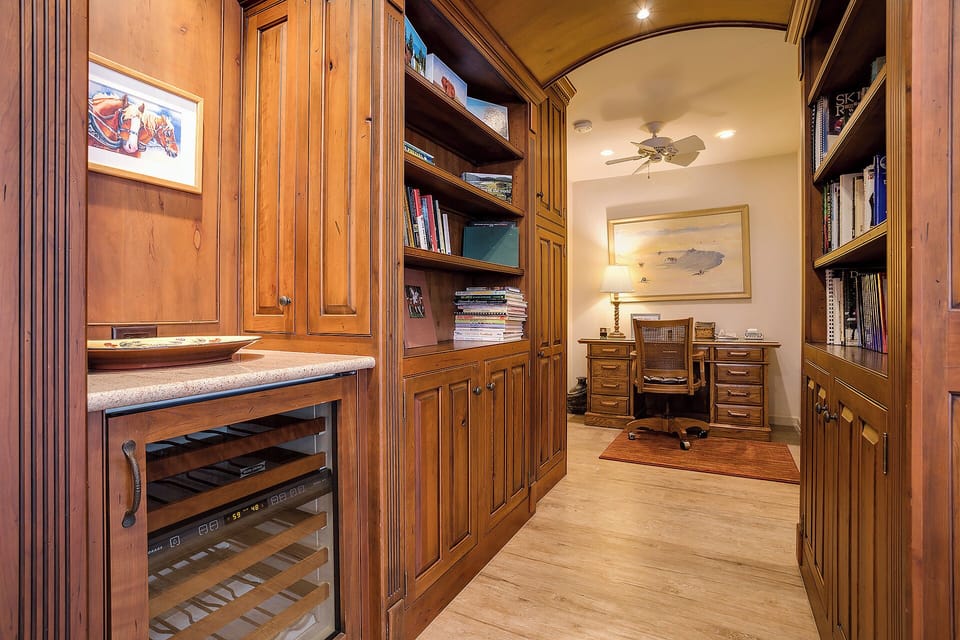 Step into your private study with rich wood cabinetry, built-in bookshelves, and a dedicated workspace where you can catch up on work or simply unwind with a good book.