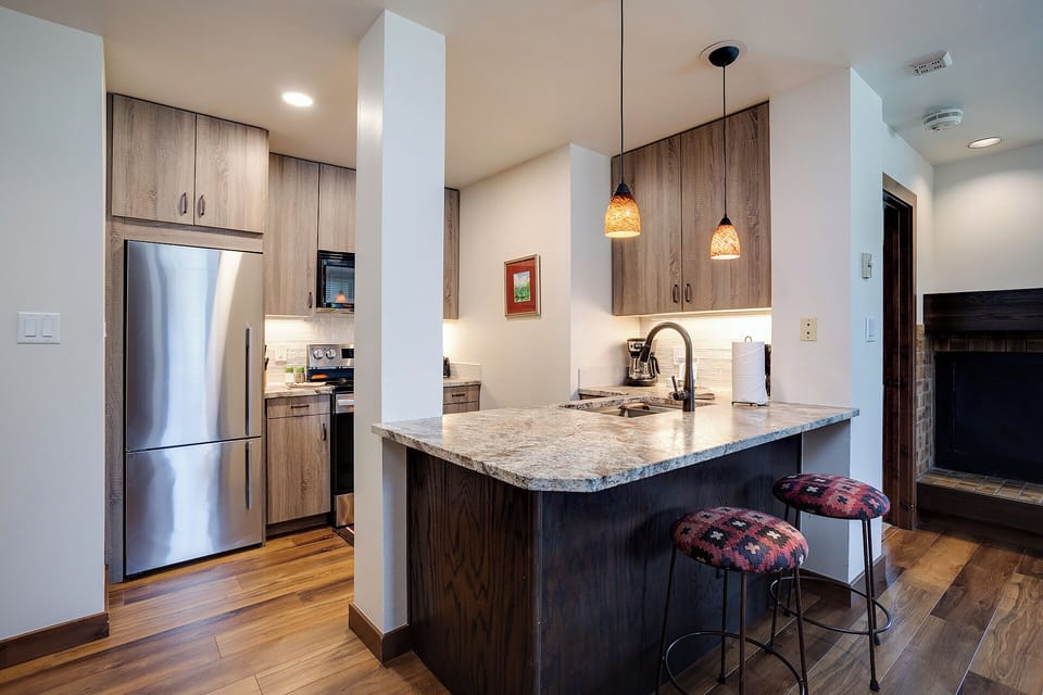 A fully equipped kitchen with modern appliances, stylish pendant lighting, and a spacious island where you can prepare meals and gather with loved ones.