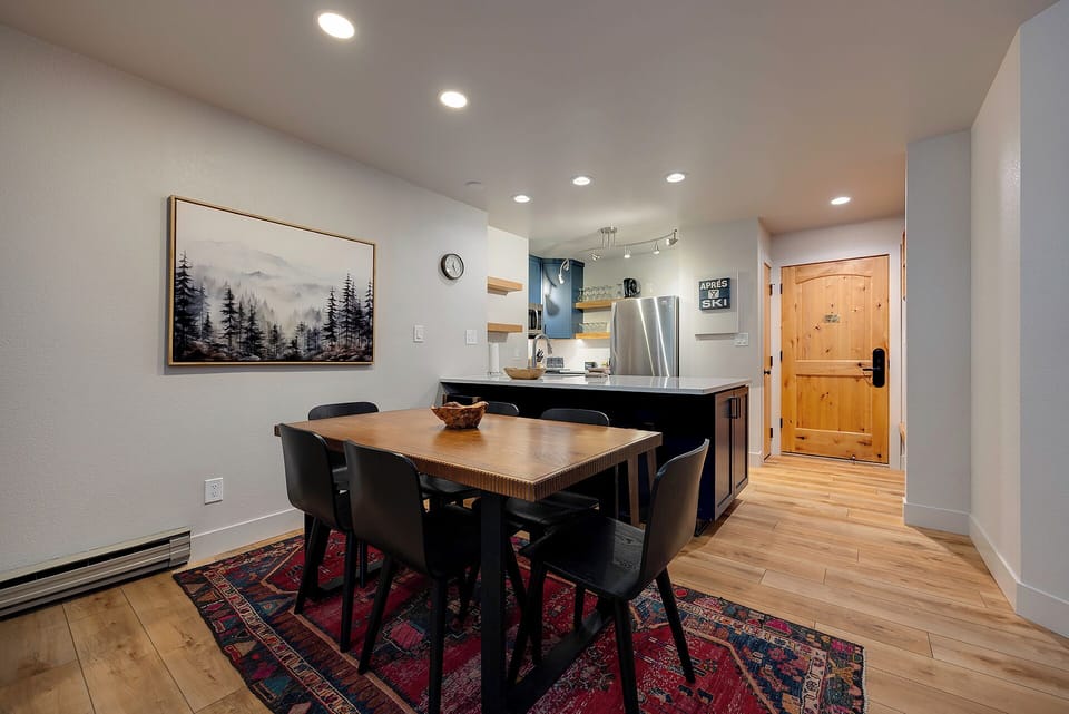 Gather around the inviting dining table where you can share meals and make memories, all within steps of your fully equipped kitchen and cozy mountain retreat.