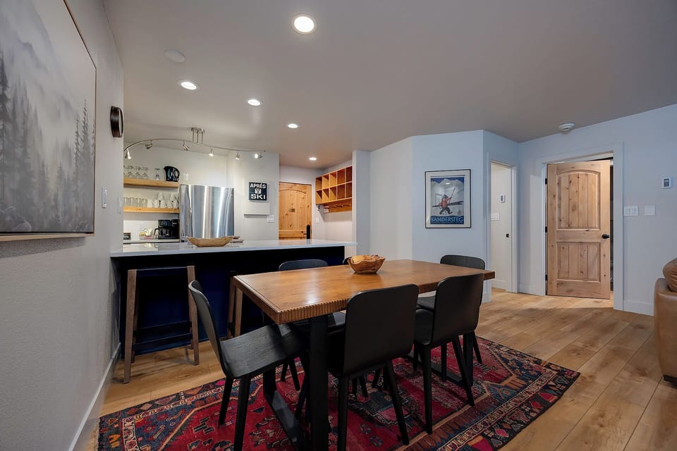 Gather around your inviting dining table, perfectly positioned between your well-equipped kitchen and cozy living area. The warm wood accents and open layout create an ideal space for memorable meals with loved ones.