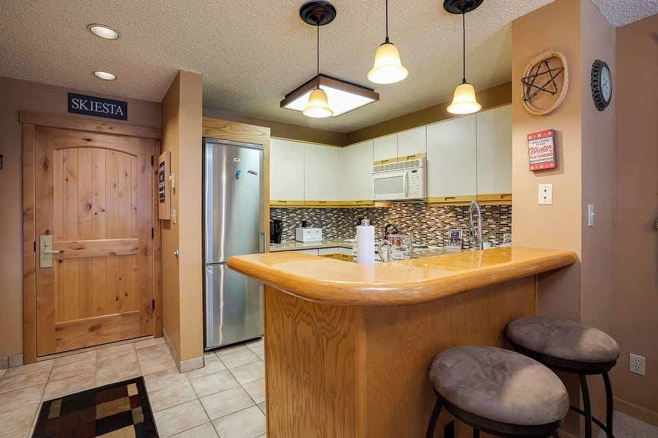 Step into your inviting kitchen with stylish breakfast bar seating, modern appliances, and everything you need to prepare delicious meals during your stay.
