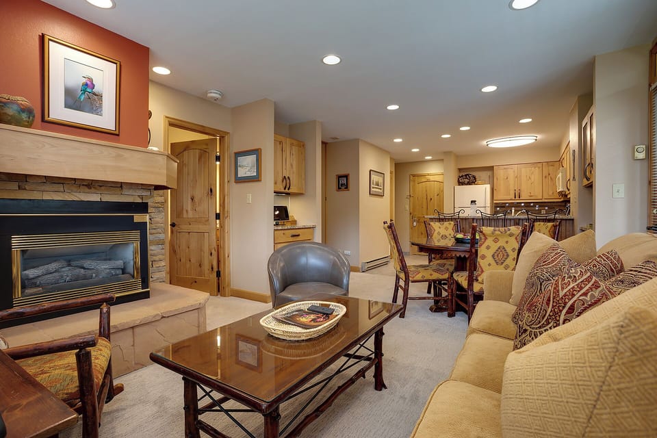Relax in this warm, open-plan living space with a cozy fireplace, plush seating, and a dining area perfect for sharing meals. You'll love the cabin-style details and fully-equipped kitchen.