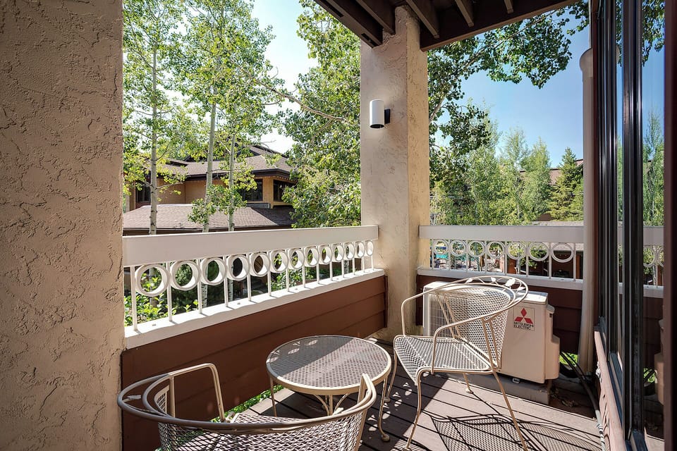 Step outside to your private balcony where morning coffee tastes better in the fresh mountain air. Sunshine filters through mature trees while you plan the day's adventures.