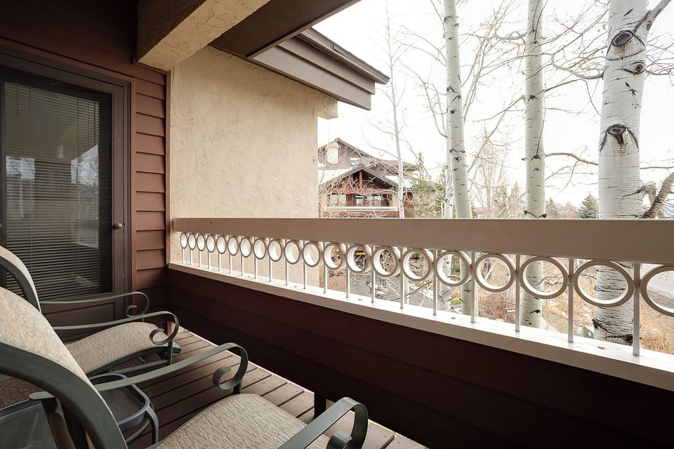 Step onto your private balcony and breathe in the crisp mountain air while gazing at towering aspens and charming alpine architecture just beyond your retreat.