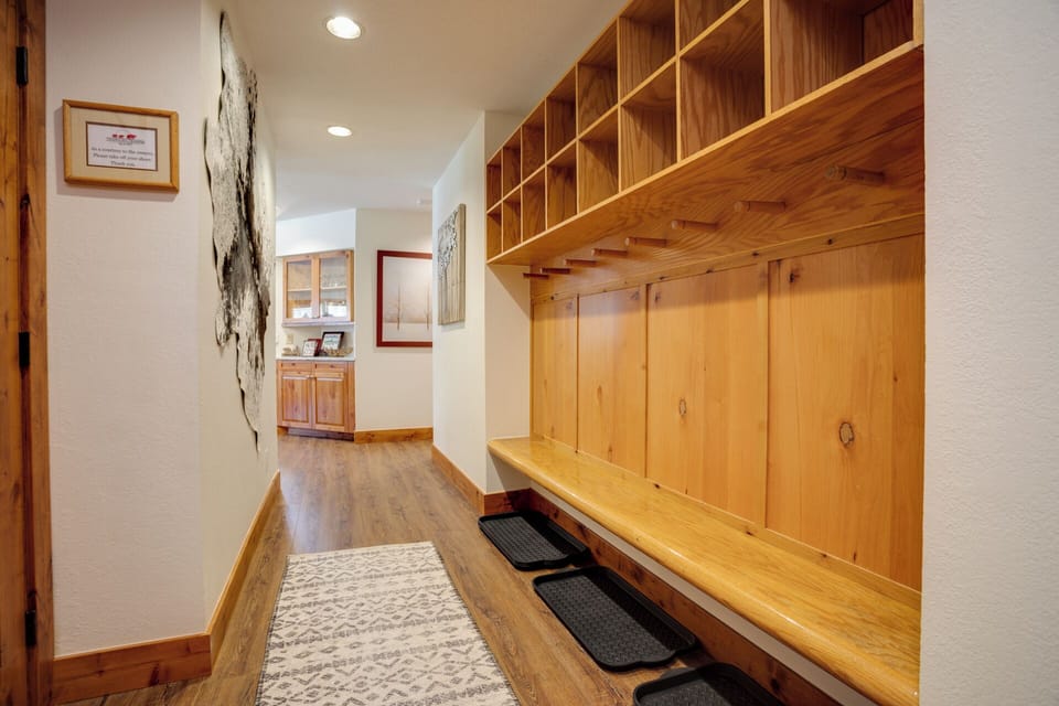 Step inside to find a welcoming entryway with custom wood storage cubbies and a built-in bench—perfect for organizing your ski gear and settling in after a day exploring.