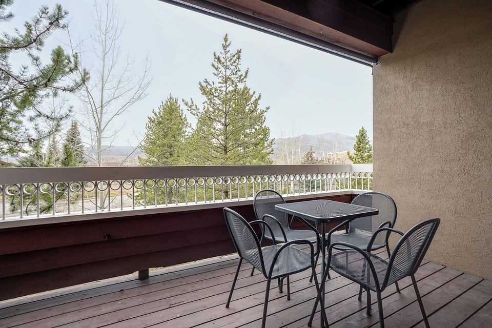 Enjoy your morning coffee or evening wind-down at this private balcony table, where mountain vistas and towering pines frame every peaceful moment of your stay.