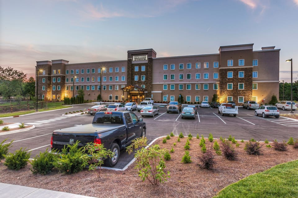 Exterior at dusk with a covered entrance and 101 complimentary parking spaces on-site