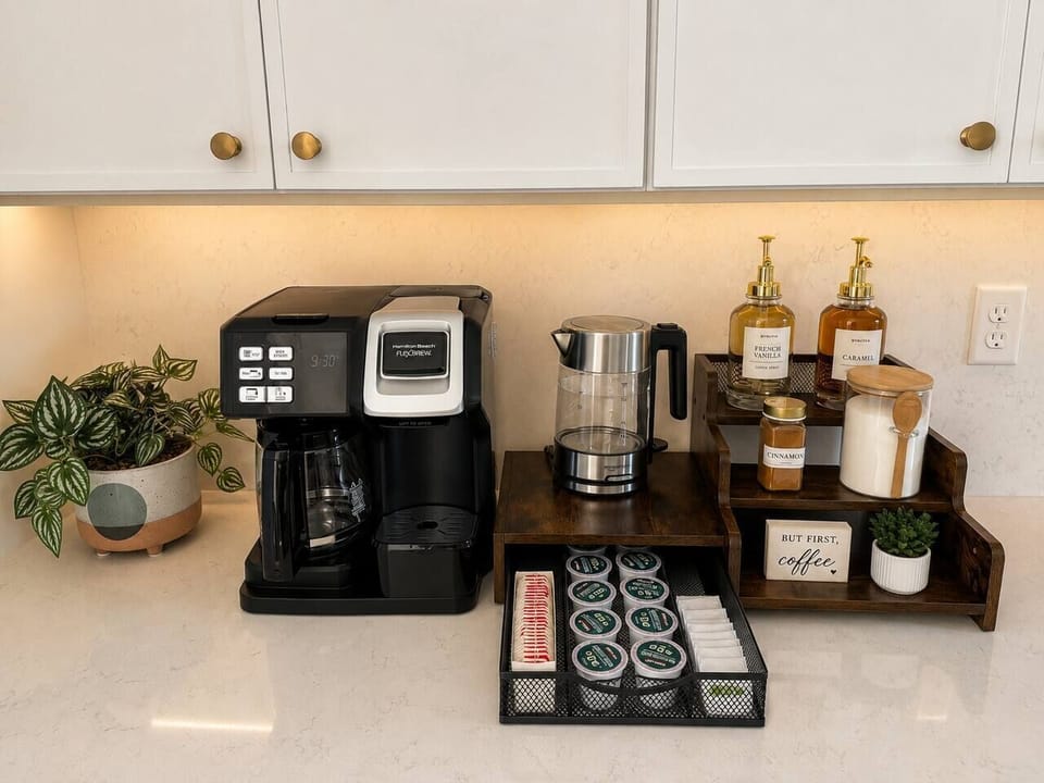 Fully stocked coffee bar w/ coffee pods, tea, sugar, and flavored syrups.