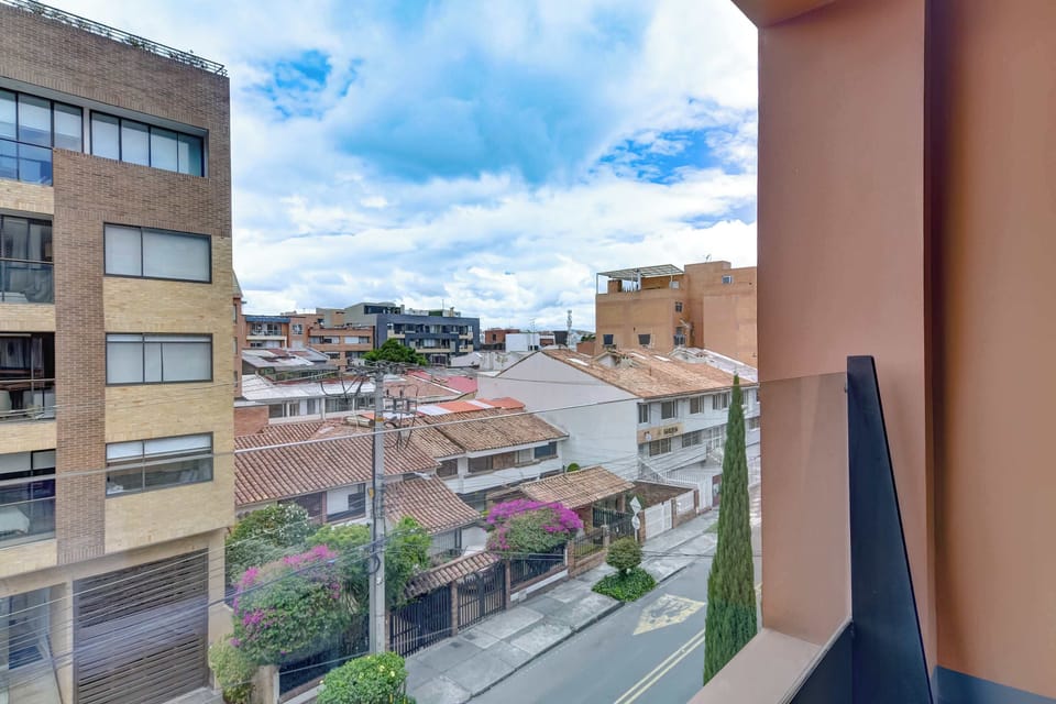 Balcony view overlooking the neighborhood and surrounding cityscape.