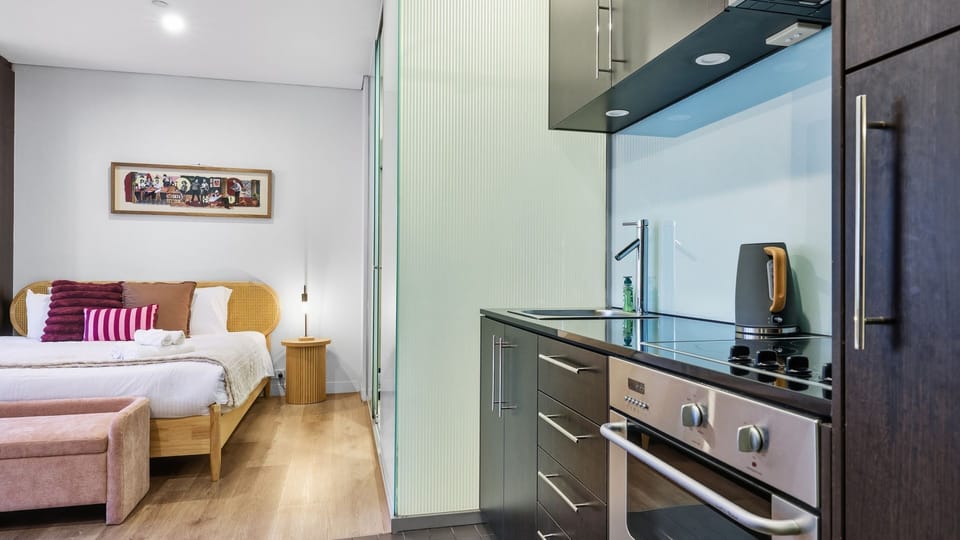 View looking from the bedroom area toward the modern kitchenette.