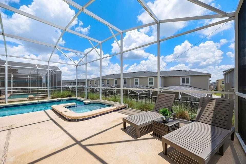 Screened in private pool and hot tub with loungers