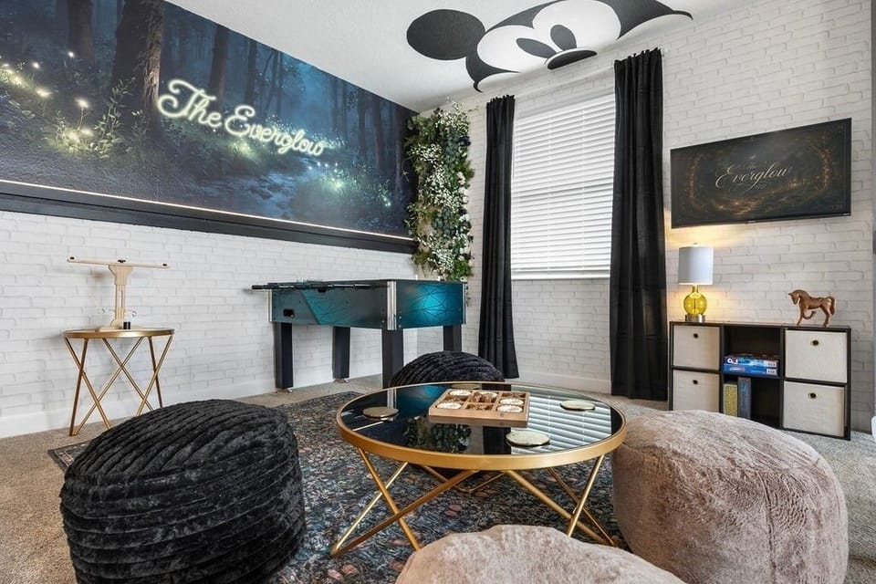game room featuring Smart TV, lounge space with game table, foosball table